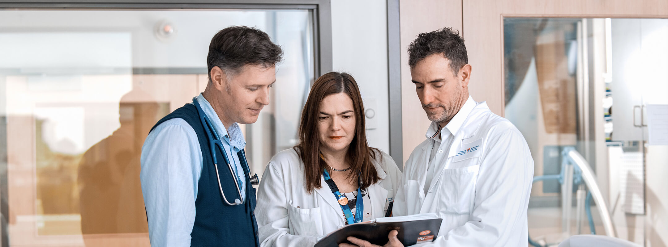 A group of doctors looking at a medical record