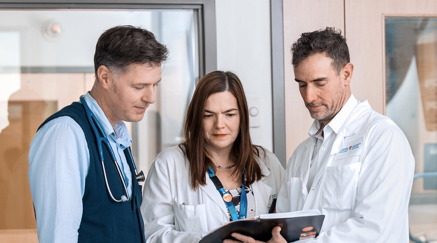 A group of doctors looking at a medical record